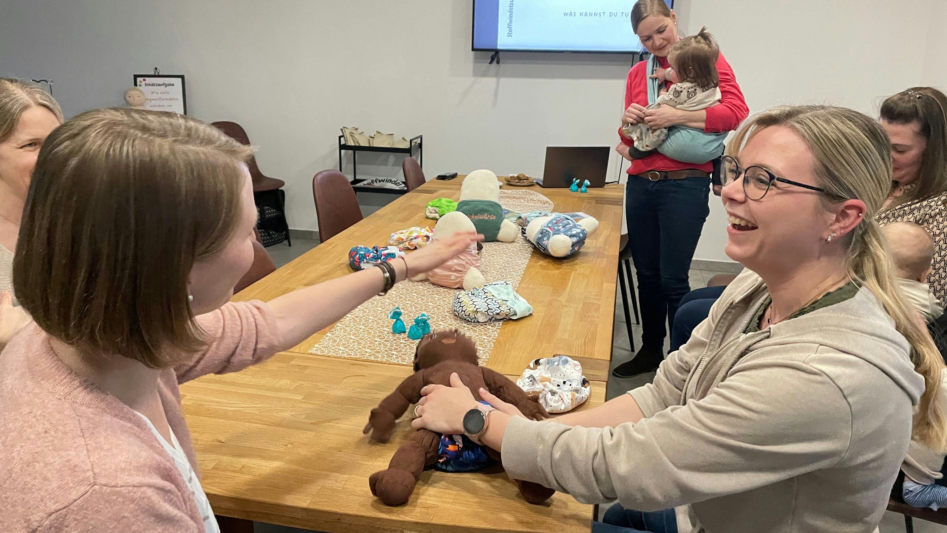 Übungsobjekt: An einer Puppe zeigt Ellen Pleiter (rechts) Müttern, wie die Stoffwindel angelegt wird. Foto: Meyer