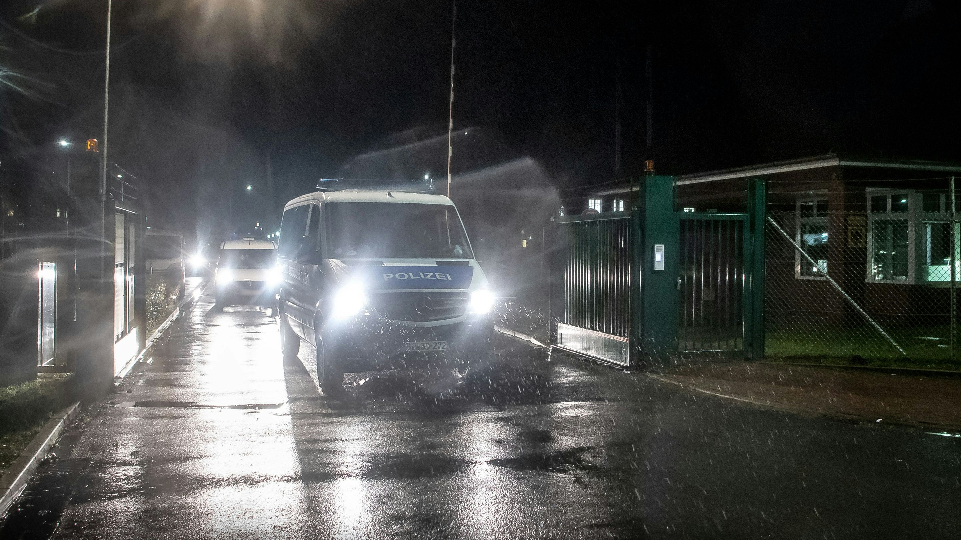 Einsatzfahrzeuge der Polizei begleiten einen Kühltransporter vom Gelände der Artlandkaserne der Bundeswehr. Foto: Sina Schuldt / dpa
