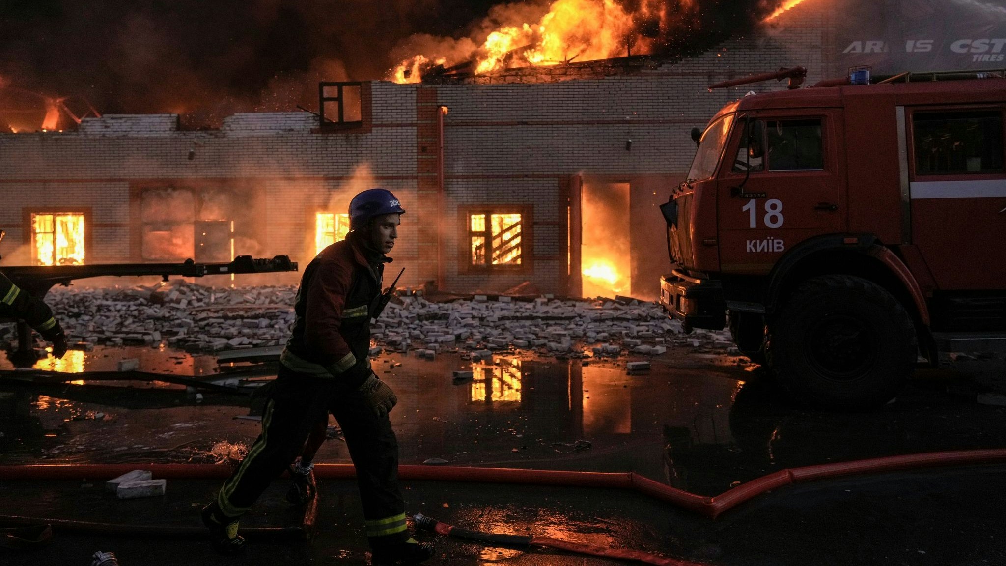 Ukrainische Feuerwehrleute löschen einen Brand in einem Lagerhaus nach einem Bombenanschlag. Foto: dpa/Ghirda