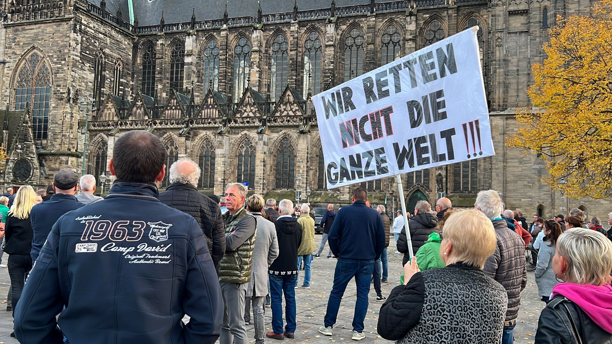 "Wir retten nicht die ganze Welt" steht auf dem Schild, das Menschen bei einer Demonstration tragen. Foto: dpa/Schulz