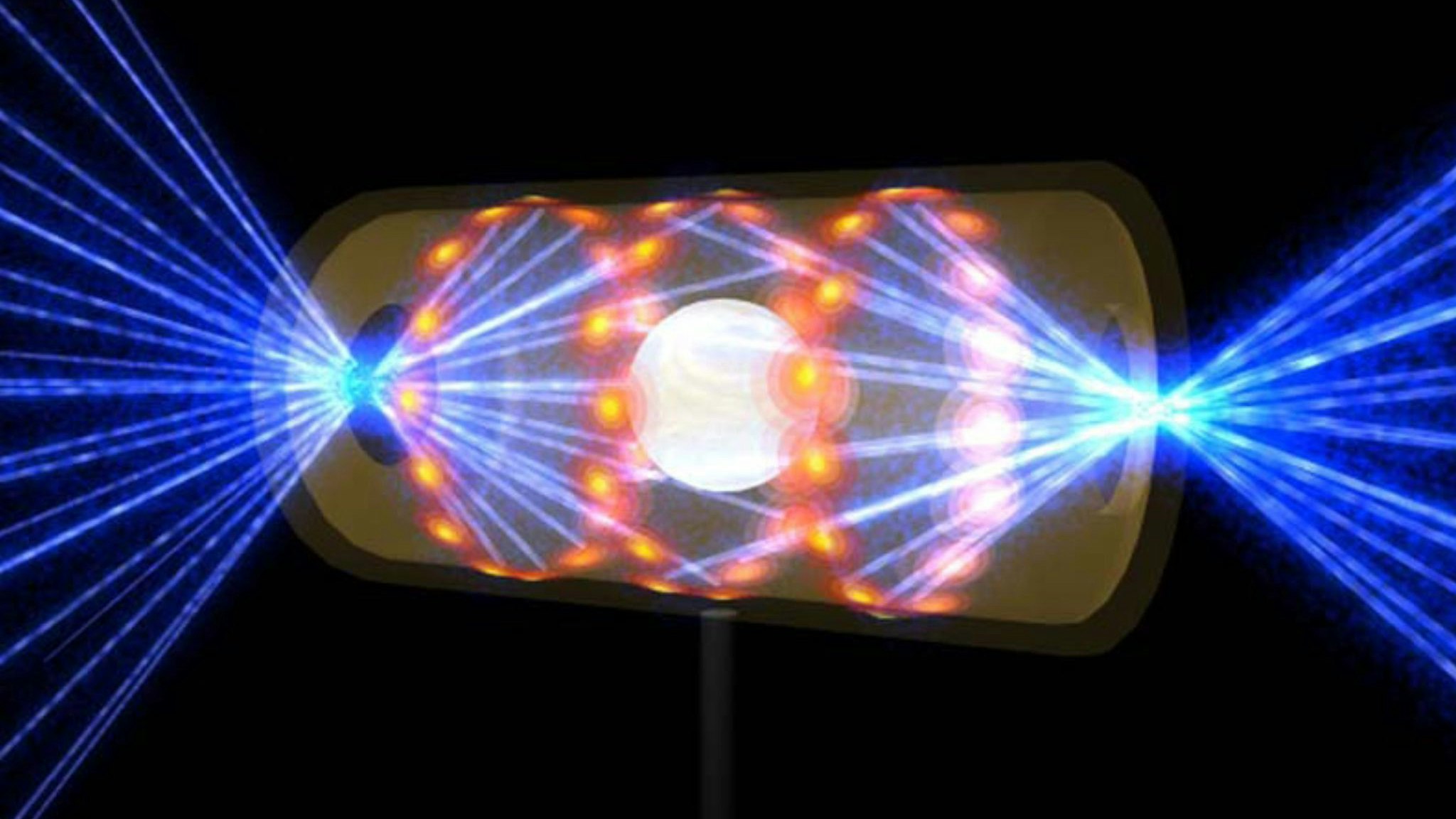 Diese Illustration zeigt ein NIF-Target-Pellet in einer Hohlraumkapsel mit Laserstrahlen, die durch Öffnungen an beiden Enden eintreten. Die Strahlen komprimieren und erhitzen das Target auf die Bedingungen, die für die Kernfusion erforderlich sind. Foto: dpa