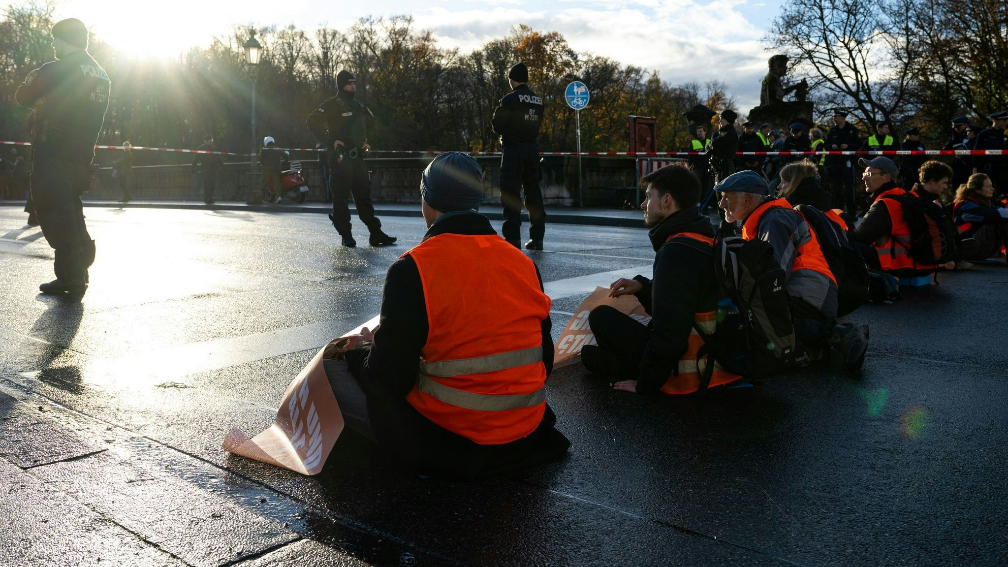Klimaaktivisten der Umweltschutzbewegung „Letzte Generation“ sitzen auf einer Straße. Foto: dpa/Preiss
