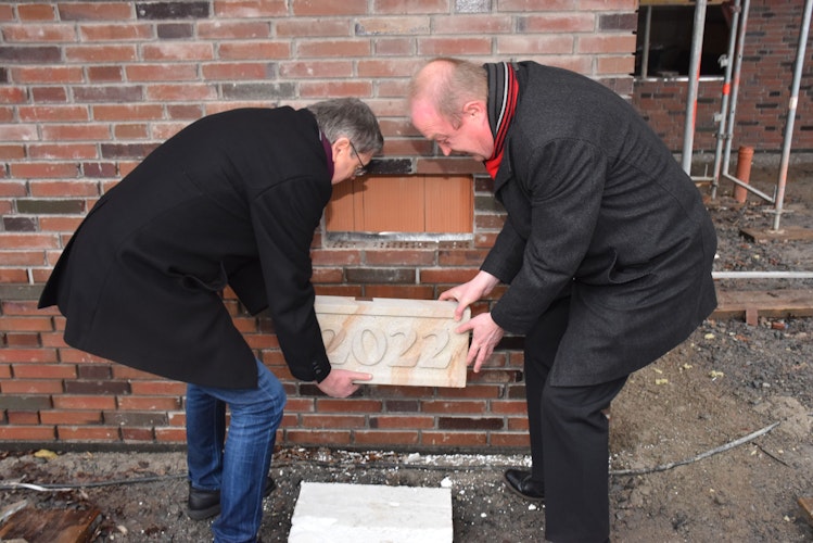 Setzten den symbolischen Grundstein in das Mauerwerk: Bürgermeister Carl Heinz Putthoff (links) und Dechant Heiner Zumdohme. Foto: Böckmann